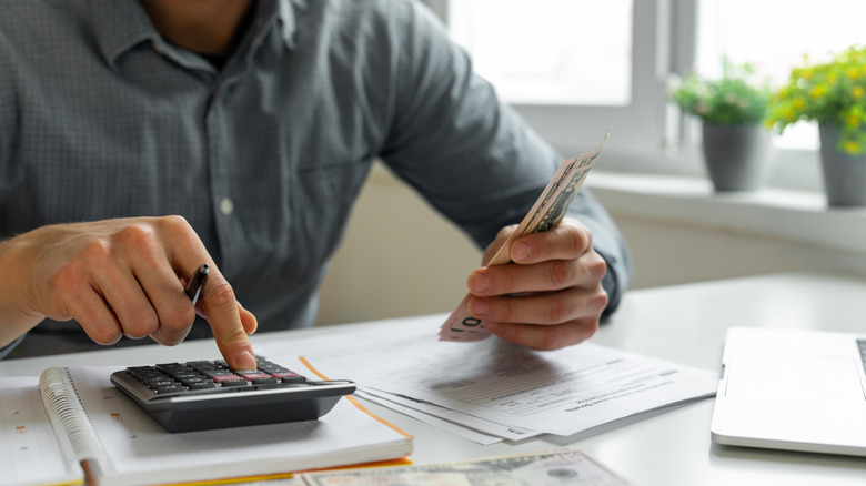 man calculating tax credits