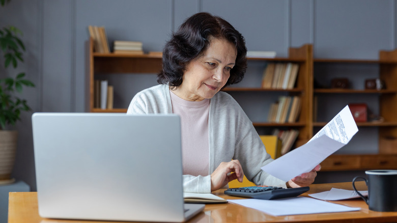 Older woman paying bills