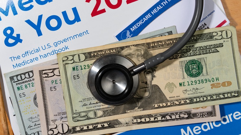 money, stethoscope and a Medicare handbook