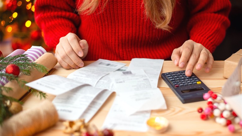 Person budgeting holiday expenses