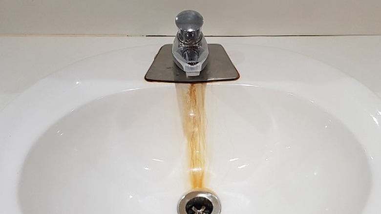 Rust stains on sink underneath a leaky faucet
