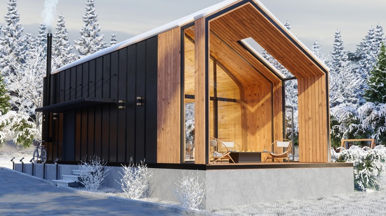 Exterior of wooden tiny house out in the snow