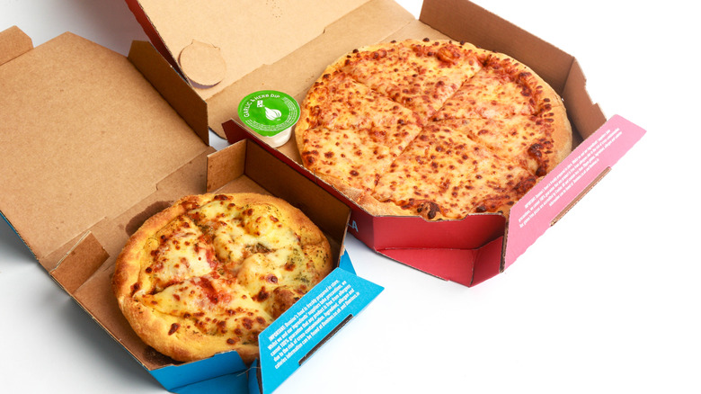 Boxes containing two different sizes of Dominos pizza