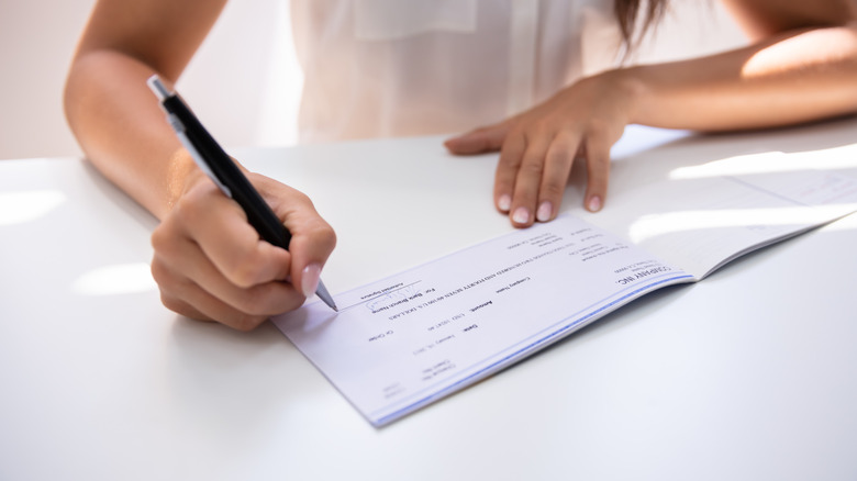 Woman writing out check