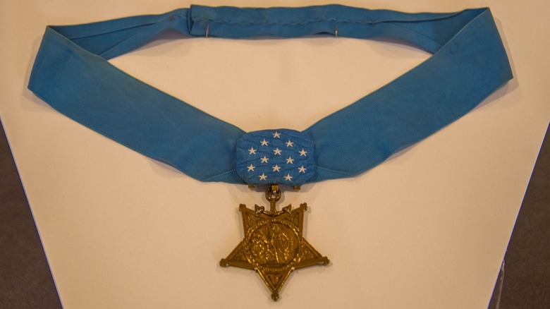 The U.S. Medal of Honor displayed on a light blue neck ribbon with white stars and a gold star-shaped medal