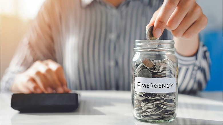 Person funding emergency money jar