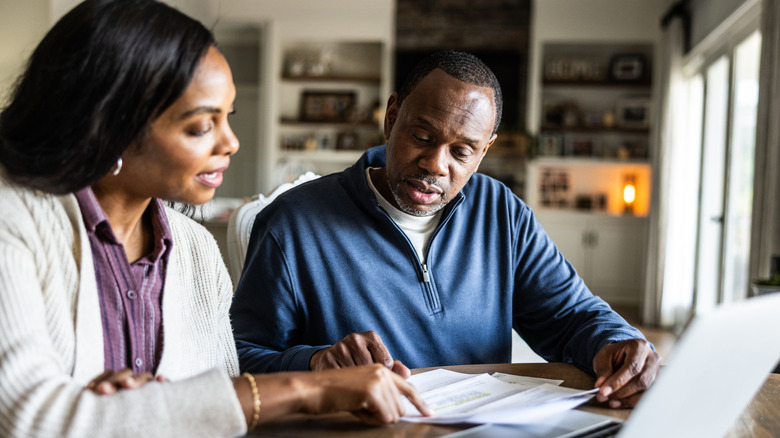An older couple looking at bank statements.
