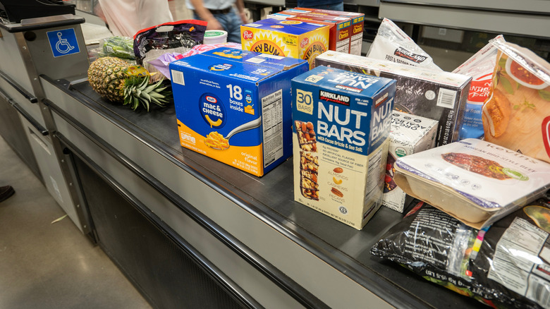 A conveyor belt at the checkout line in Costco with a variety of products on it