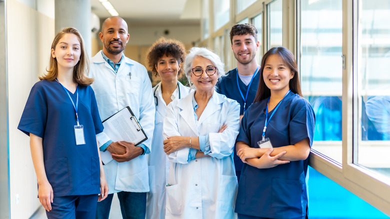 A group of doctors standing next to a window