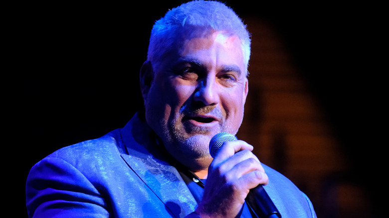 Singer Taylor Hicks smiling while holding a microphone
