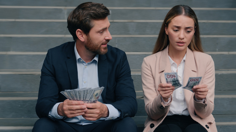 Man and women counting money.
