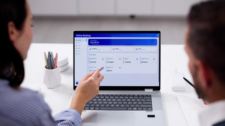 Couple checking bank account on computer.