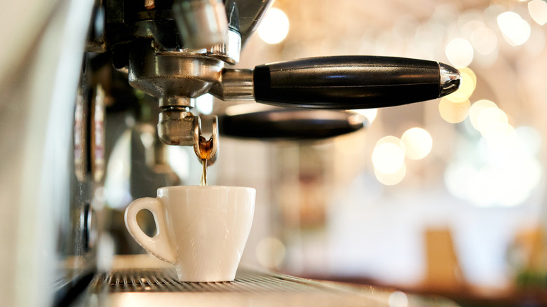 Espresso machine dripping coffee into mug
