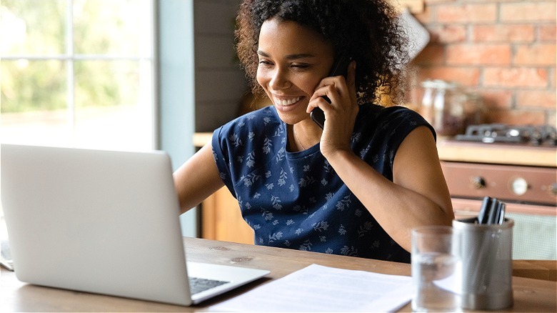 Person smiling, speaking on phone