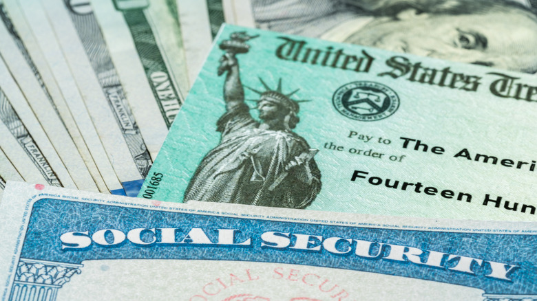 Social Security card with dollar bills and check