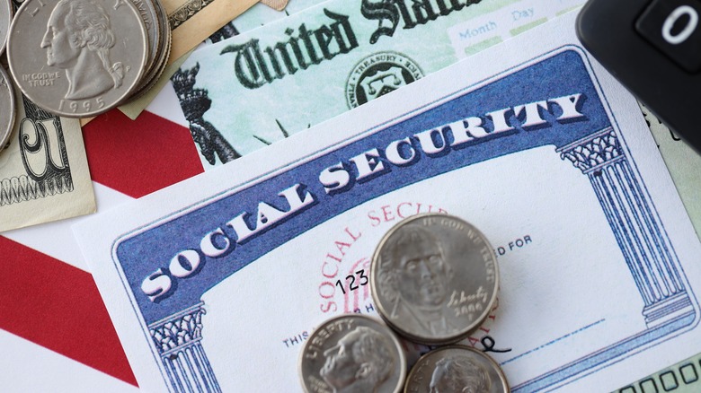 Social Security card with coins and dollars
