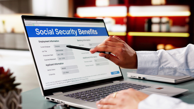 Person using laptop with screen opened to a Social Security benefits webpage