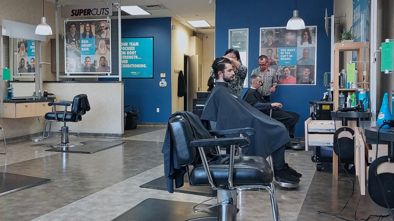 Staff and customers inside a Supercuts salon