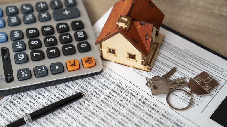 calculator and doc showing housing costs