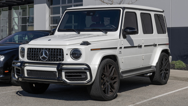 A white 2021 Mercedes-Benz G 63 AMG revesrse parked outside of a dealership