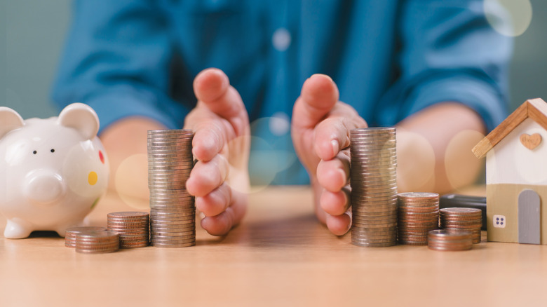 Man equally dividing up stacks of coins