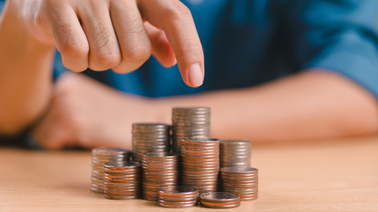 Hands counting up stacks up coins