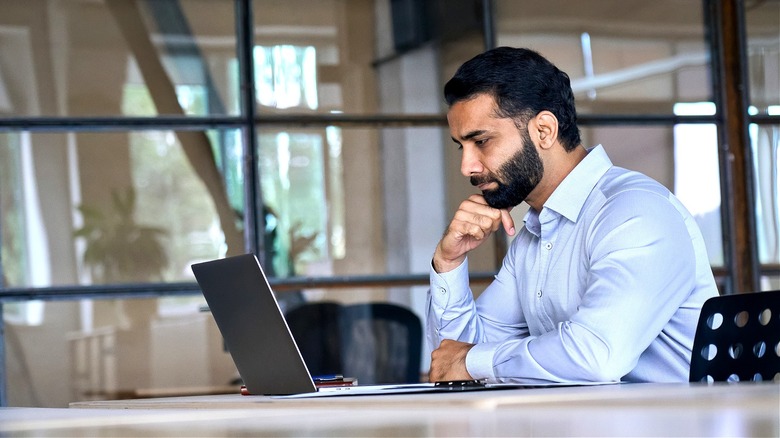 Person at table using laptop