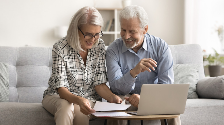 A happy older couple using a computer