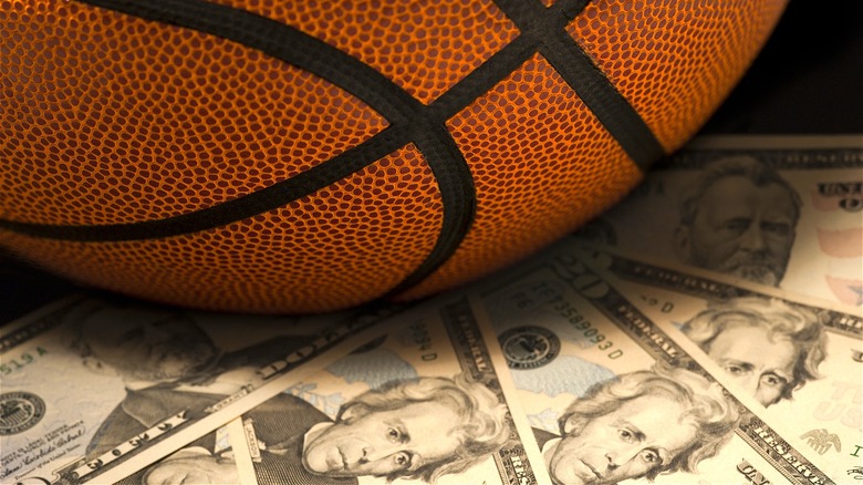 A basketball surrounded by money
