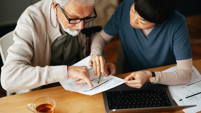 nurse and retiree looking at documents