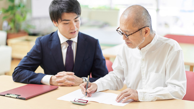 People discussing a document