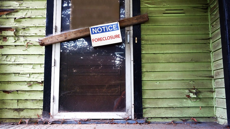 Old home with foreclosure sign
