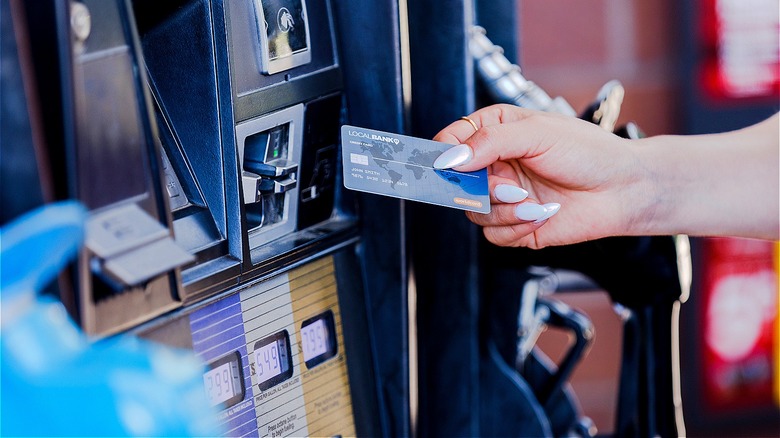 Person paying for gasoline