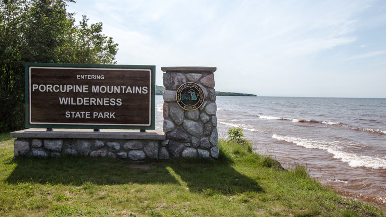 The "Entering Porcupine Moountains Wilderness State Park" sign next to Lake Superior.