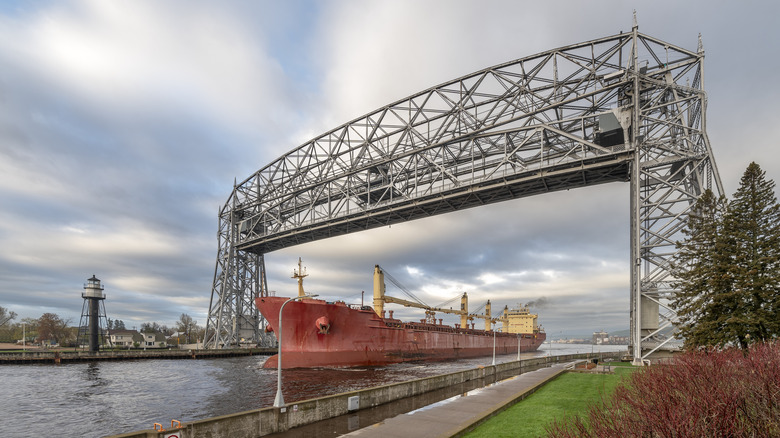 A large cargo ship passing thorough the canal under the lift bridge in Duluth, Minnesota.