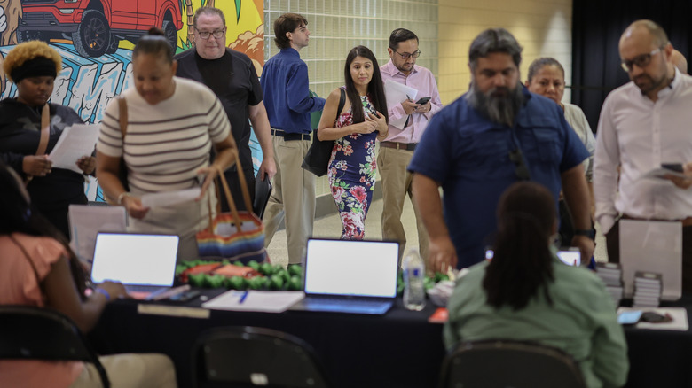 Job seekers line up at a job fair held at Amerant Bank Arena in Sunrise, Florida.