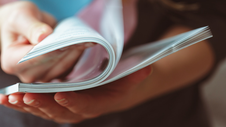 A woman reading magazine at home.