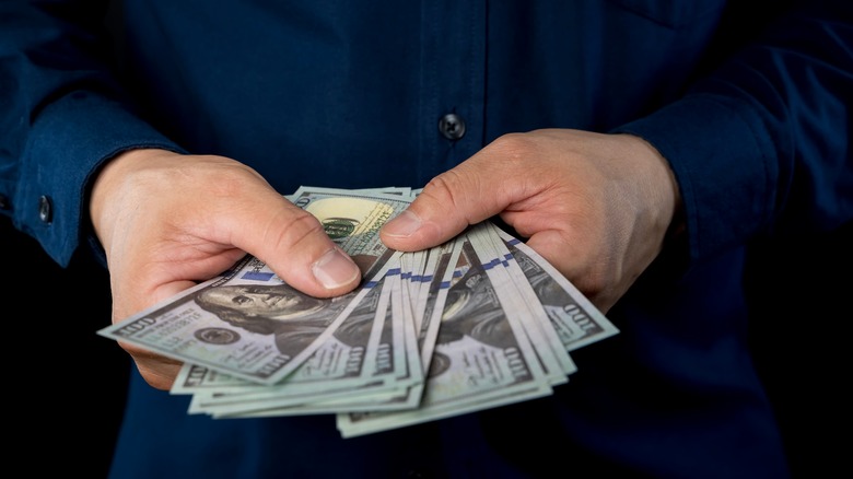Close up of businessman counts money in hands