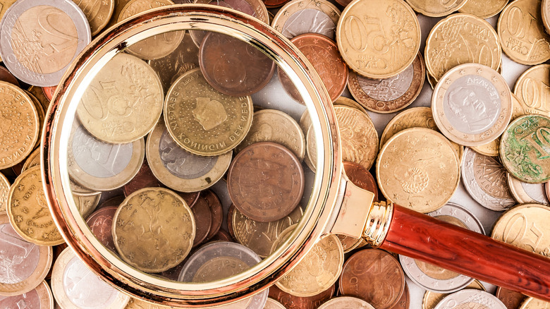 Magnifying glass with coins