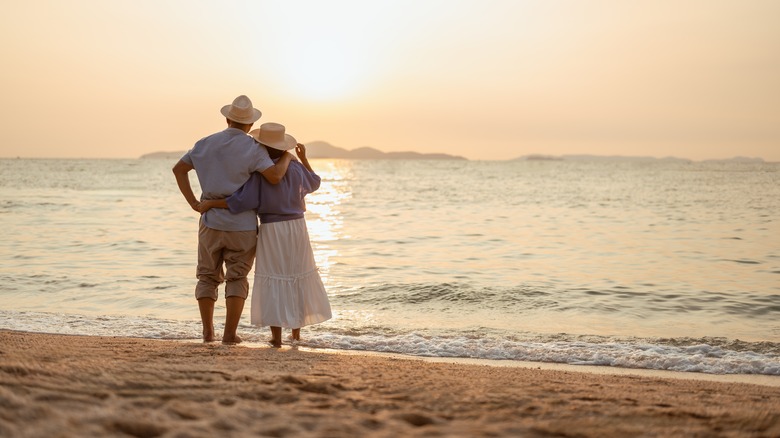 Couple watching the sunset on the beach
