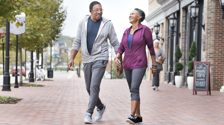 Elderly couple walking in small town
