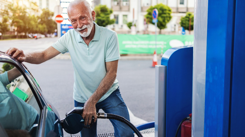 Senior man filling a car with gas