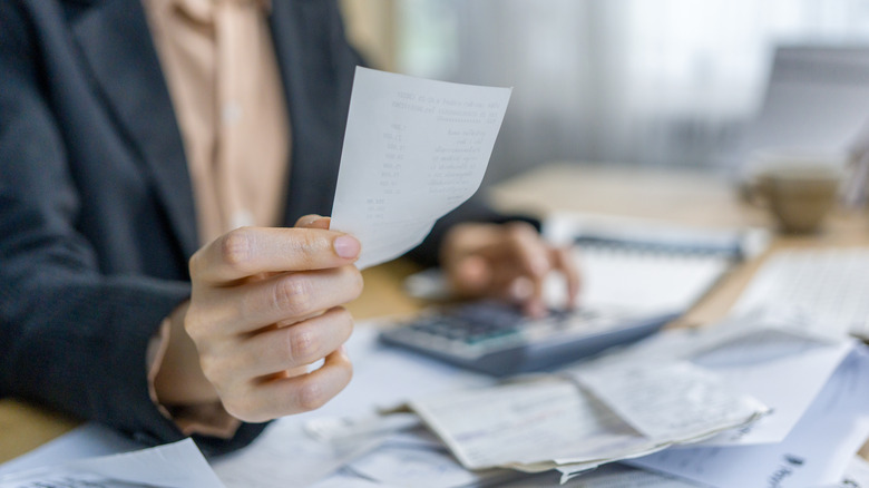 person at a deck looking over receipts