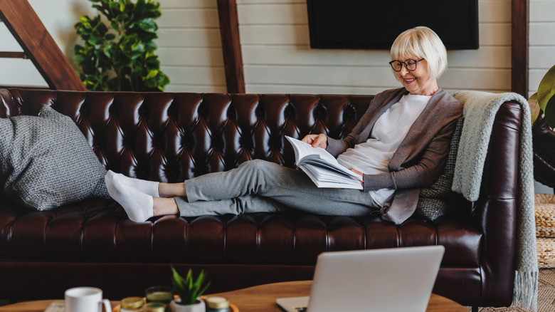a senior sitting on a leather couch