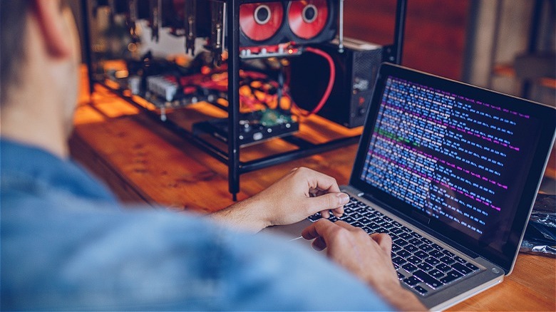 Person mining bitcoin on computer