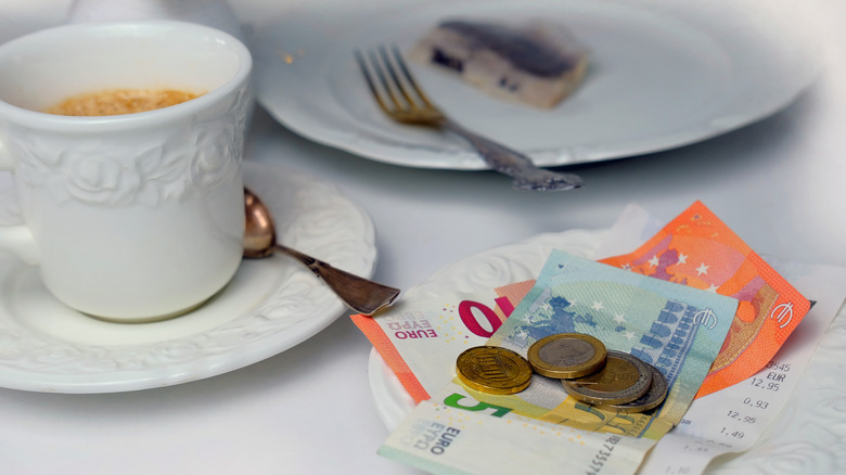 Euros left as a tip for coffee and food on table