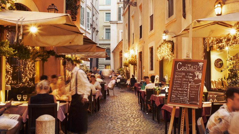 Street in Italy filled with restaurants and diners
