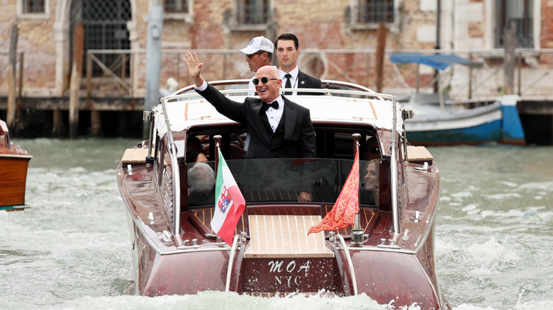 Jeff Bezos at his Venetian wedding, waving from a boat in the canal