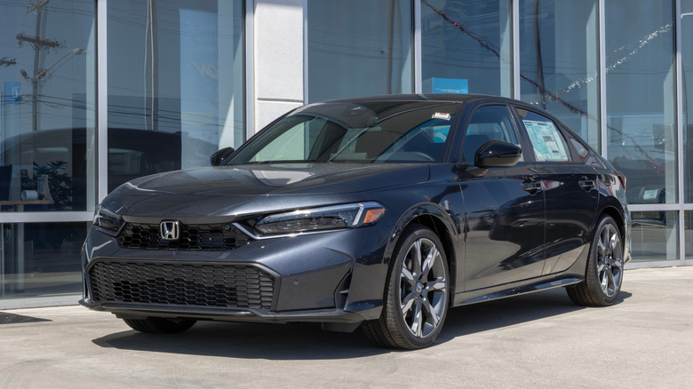 A dark grey Honda Civic on display at a dealership.