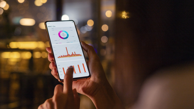 Person using stock management app on phone